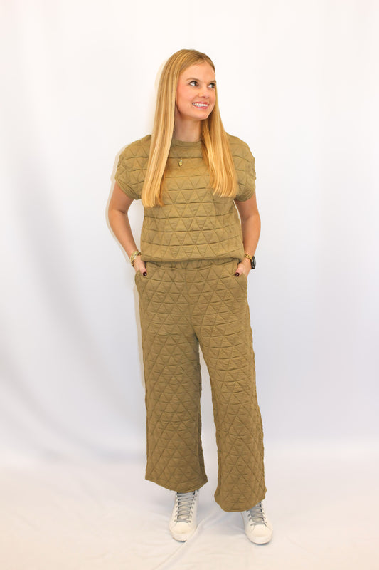 "Alt text: Shop McRae's chic quilted two-piece set featuring a comfy boxy top and cropped wide-legged trousers with side pockets. A stylish yet cozy ensemble, perfect for turning heads and adding a touch of luxury to any occasion."