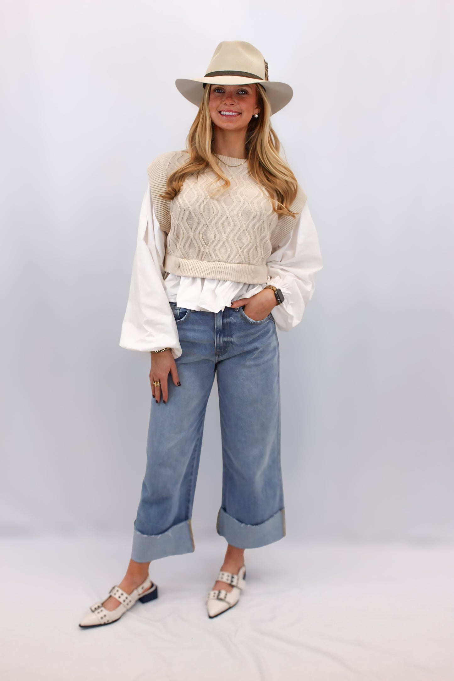 "Alt text: Amelia Woven Balloon Sleeve Top with a soft cable knit sweater bodice and dramatic poplin balloon sleeves. Features an open back with a self-tie detail, blending cozy charm with elegant flair. Perfect for pairing with high-waisted jeans or skirts for a chic, statement-making look."