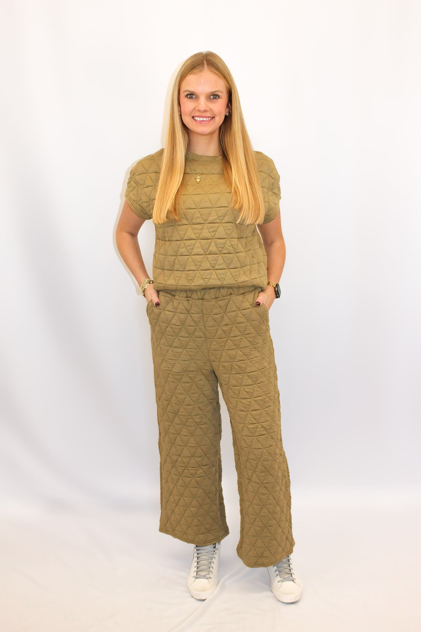 "Alt text: Shop McRae's chic quilted two-piece set featuring a comfy boxy top and cropped wide-legged trousers with side pockets. A stylish yet cozy ensemble, perfect for turning heads and adding a touch of luxury to any occasion."