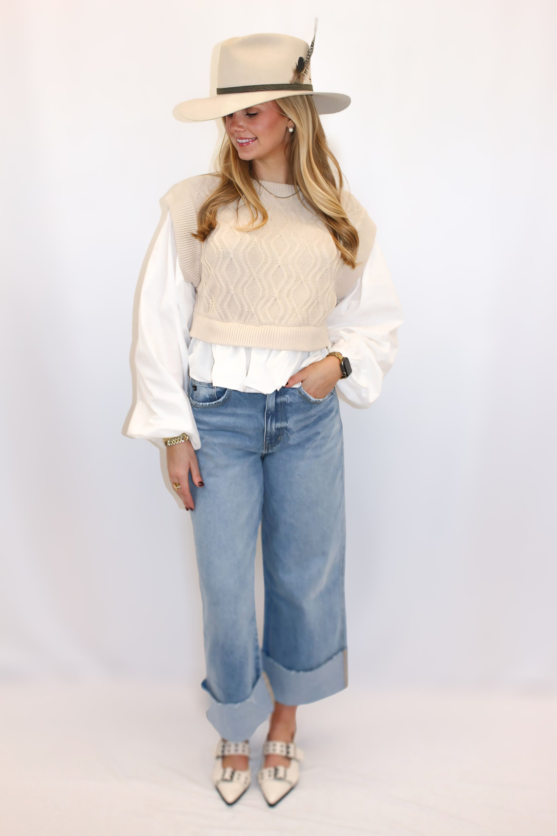 "Alt text: Amelia Woven Balloon Sleeve Top with a soft cable knit sweater bodice and dramatic poplin balloon sleeves. Features an open back with a self-tie detail, blending cozy charm with elegant flair. Perfect for pairing with high-waisted jeans or skirts for a chic, statement-making look."