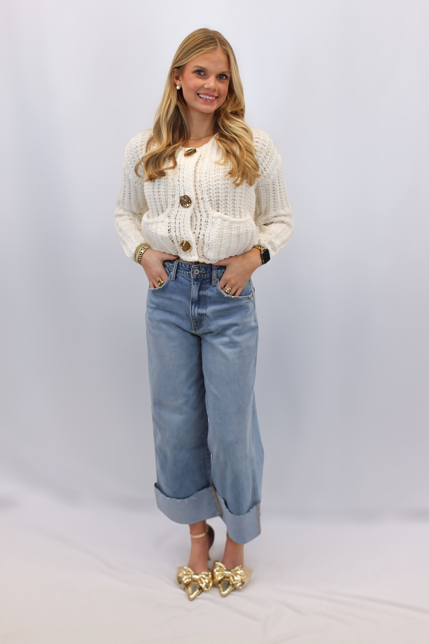 "Alt text: A cozy Alli Knit Essential Cardigan in a solid color, made of soft, stretchy fabric. The cardigan features a round neck, long sleeves, a front button opening, and convenient pockets. Perfect for layering, it offers a relaxed, laid-back vibe suitable for lounging at home or going out."